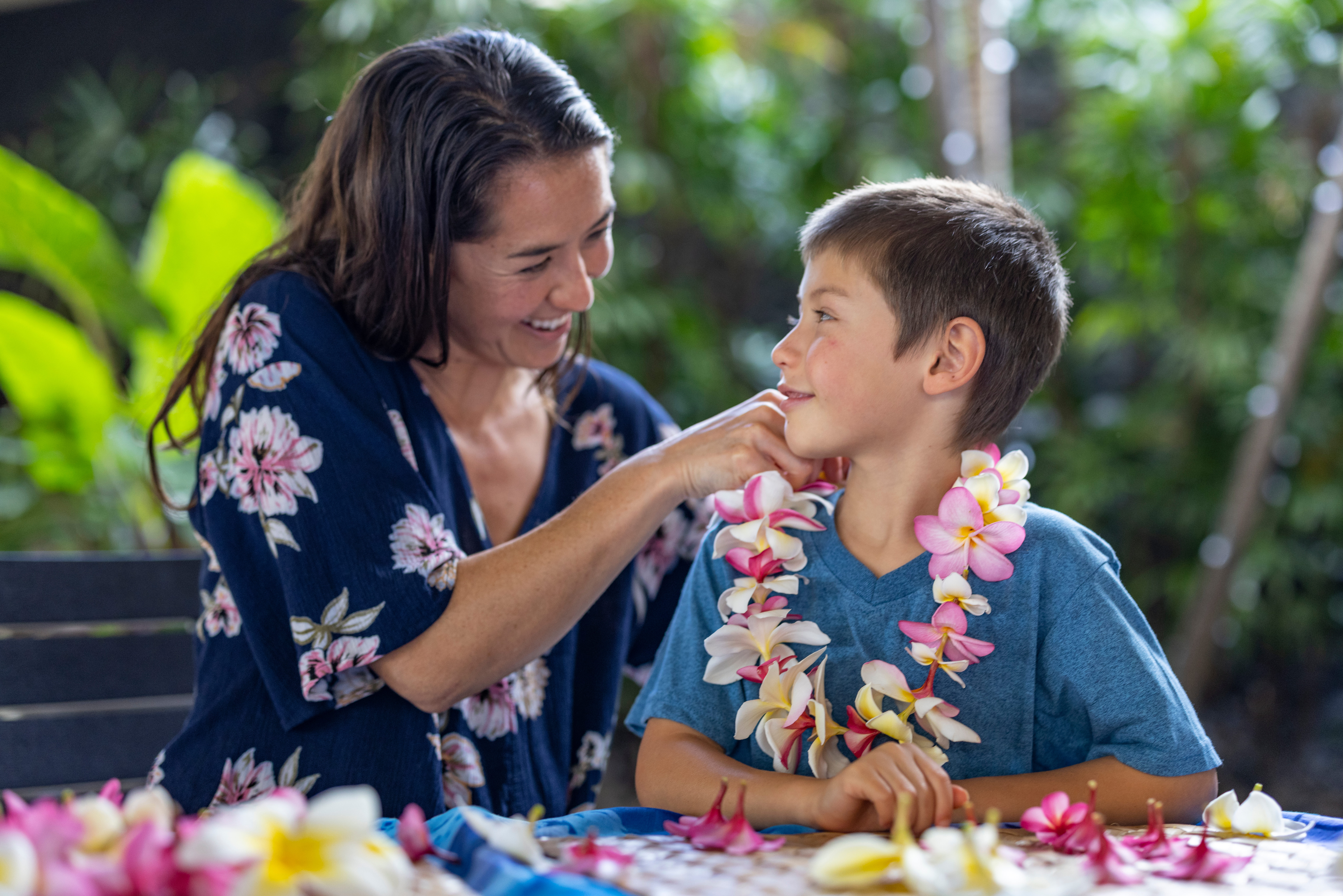 Mother and son making a lei